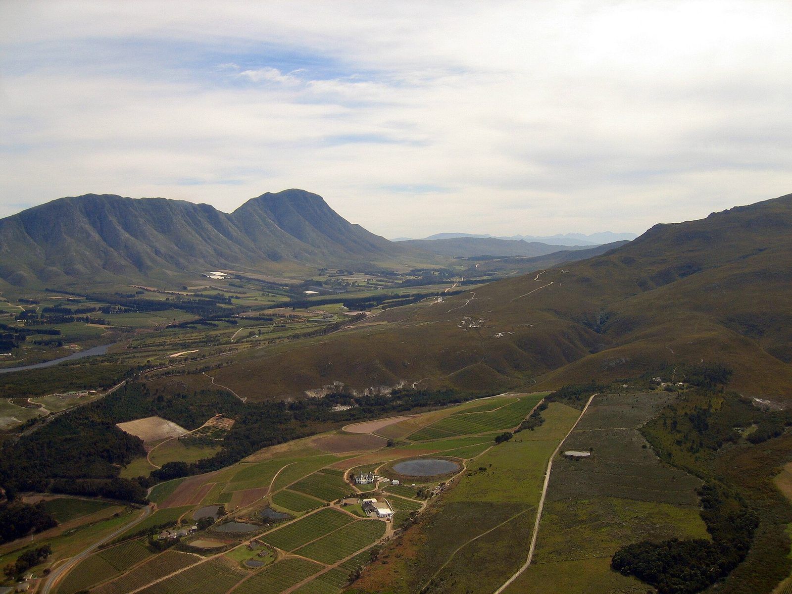 Aerial view over the Hemel-en-Aarde Valley near Hermanus, vineyard blocks and wine farms set between the mountains