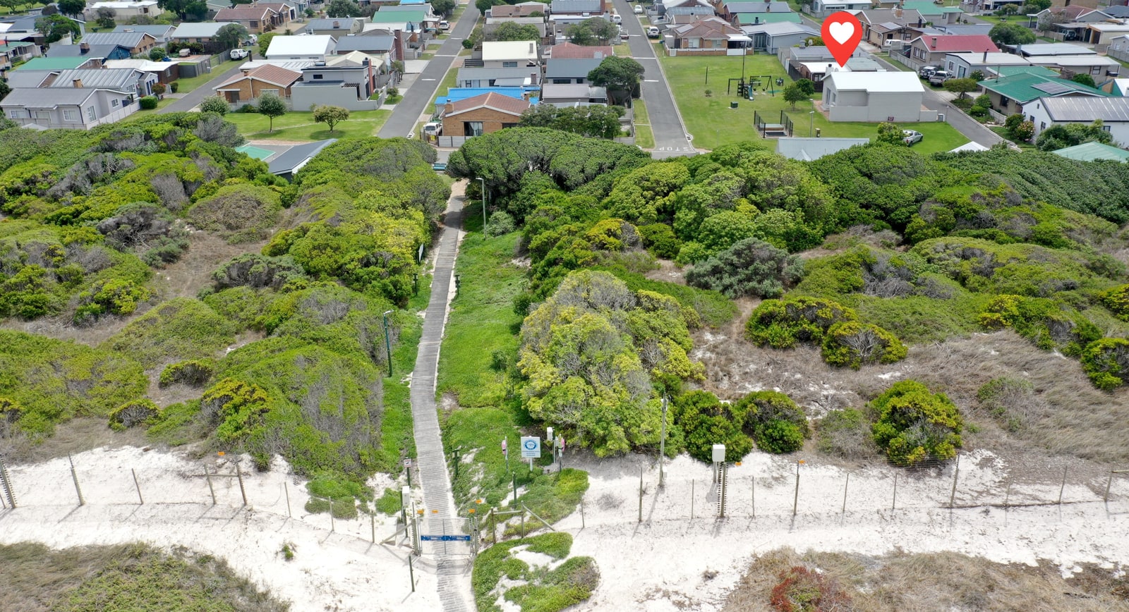 Beach access path from the resort to the sand The beach access path from Pearly Beach Resort to the dunes and beach, framed by green coastal vegetation